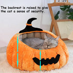 Load image into Gallery viewer, Gray cat resting inside a soft plush Halloween pumpkin cat bed with raised backrest for security and comfort