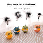 Load image into Gallery viewer, Four colorful rotating feather cat toys with catnip and track balls on a striped surface in soft light