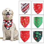 Load image into Gallery viewer, Golden retriever wearing a Christmas dog bandana with Santa print next to six holiday-themed pet scarves in various colors and patterns.