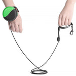 Load image into Gallery viewer, Hand wearing wrist-type retractable pet leash with 3M strap holding dog leash handle for hands-free walking