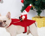 Load image into Gallery viewer, Small dog wearing a Santa Claus riding reindeer costume with Christmas tree and gift in background