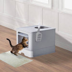 Load image into Gallery viewer, Grey enclosed cat litter box with slide-out tray and top-exit design shown with a cat entering from front opening