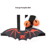 Load image into Gallery viewer, Black felt batwing pet costume with red detailing and attached orange pumpkin bells for Halloween cats and dogs