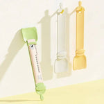 Load image into Gallery viewer, Cat strip feeder spoons in green, white, and yellow for dispensing lickable wet food for cats and dogs.