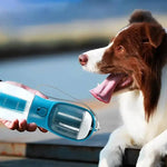 Load image into Gallery viewer, 3-in-1 portable dog water bottle dispenser being used to hydrate a brown and white dog outdoors by the water