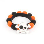Load image into Gallery viewer, Halloween pet collar with orange and black fur balls and a white skull charm for dogs and cats