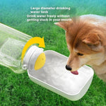 Load image into Gallery viewer, Dog drinking water from a portable 2-in-1 water bottle and food container with integrated feeding bowl outdoors