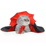 Load image into Gallery viewer, Gray cat wearing a red and black cosplay vampire cloak pet costume lying down on white background