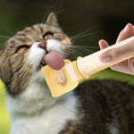 Load image into Gallery viewer, Cat licking wet food from a reusable squeeze feeder spoon designed for cats and dogs feeding.