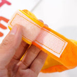 Load image into Gallery viewer, Close-up of hand holding adjustable velcro strap on Halloween pet pumpkin hat costume accessory