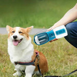 Load image into Gallery viewer, Happy corgi sitting on grass next to person holding 3-in-1 portable dog water bottle with feeder and bowl combo