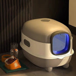 Load image into Gallery viewer, Oversized enclosed cat litter box with blue UV sterilization light, designed for odor control and easy cleaning.