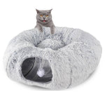 Load image into Gallery viewer, Gray cat sitting on a foldable plush winter cat tunnel nest with a small hanging toy inside the soft kennel