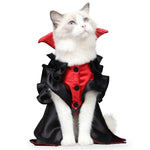 Load image into Gallery viewer, White cat wearing a red and black vampire costume with a cape and ruffled collar for Halloween or cosplay.