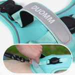 Load image into Gallery viewer, Hand attaching leash to turquoise no-pull dog harness with reflective handle and GPS tag slot for secure outdoor use.