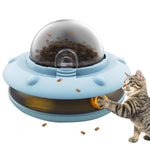 Load image into Gallery viewer, Tabby cat playing with the interactive Flying Saucer Pet Slow Feeder, which dispenses treats through rotating yellow balls.