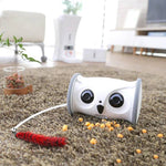 Load image into Gallery viewer, Owl Pet Robot – Interactive Toy with Camera & Treat Dispenser on carpet, surrounded by treats and a feather toy for pet engagement.