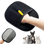 Load image into Gallery viewer, Black pet hair remover grooming glove held by hand with small dog and cats below on white background