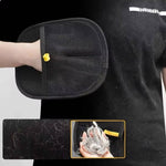 Load image into Gallery viewer, Black pet hair remover glove held by hand with accumulated cat and dog fur on surface and in hand
