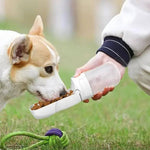 Load image into Gallery viewer, Dog eating from white 2-in-1 Pet Travel Feeder outdoors, perfect for feeding pets during walks or travel.