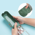 Load image into Gallery viewer, Green Portable Pet Travel Feeder with water being dispensed into foldable cup, easy one-hand operation.