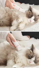Load image into Gallery viewer, Person using 4-in-1 electric pet clipper grooming a calm fluffy cat’s fur on a white surface indoors