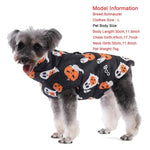 Load image into Gallery viewer, Small dog wearing a black waterproof Halloween jacket with orange pumpkin and white ghost prints, designed for warmth and windproofing.