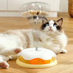 Load image into Gallery viewer, Cat playing with Interactive Cat Toy & Feeder Set in yellow, featuring a spring-mounted treat globe and rotating turntable ball base.