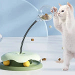 Load image into Gallery viewer, White cat playing with green Interactive Cat Toy & Feeder Set, swatting at the treat-filled globe on a flexible spring.