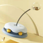 Load image into Gallery viewer, Blue Interactive Cat Toy & Feeder Set tilted on a yellow surface, showing flexible spring and treat-dispensing globe in action.