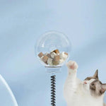 Load image into Gallery viewer, Cat reaching for treats inside the transparent globe of the Interactive Cat Toy & Feeder Set, promoting active play and slow feeding.