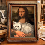 Load image into Gallery viewer, Framed Mona Lisa portrait with a cat lying on her arm, doubling as a funny scratch board and cozy pet bed.