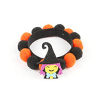Load image into Gallery viewer, Halloween pet collar with orange and black fur balls and a smiling witch decoration for dogs and cats