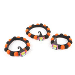 Load image into Gallery viewer, Set of three Halloween pet collars with orange and black fur balls and a witch hat charm for dogs and cats