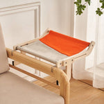 Load image into Gallery viewer, Space-saving cat hanging bed with wooden frame and fabric sling perch for window, balcony, or bedside resting spot.
