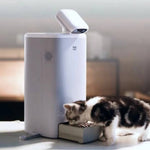 Load image into Gallery viewer, Automatic cat feeder with camera, portion control, 1080P HD video, night vision, two-way audio, and laser teaser in use by a cat.