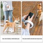 Load image into Gallery viewer, Person holding ring-shaped retractable pet leash with LED light while walking dog outdoors and using phone hands-free.
