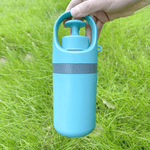Load image into Gallery viewer, Hand holding the Portable Dog Pooper Scooper – Six-Claw Grabber with Bag Slot in grassy outdoor setting, emphasizing portability and ease of use.