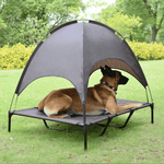 Load image into Gallery viewer, Brown elevated outdoor pet tent bed with sunshade canopy, shown with a large dog relaxing on grass in a park setting.