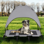 Load image into Gallery viewer, Gray elevated dog bed with canopy shade in a grassy field, featuring a medium-sized dog resting comfortably in summer.