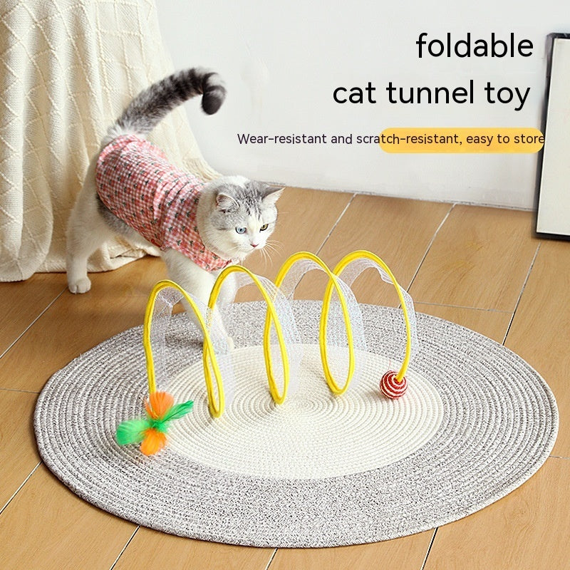 Cat playing with a foldable S type spring tunnel toy featuring attached feather and mouse for indoor fun