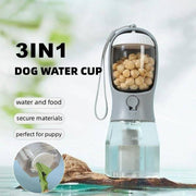 Portable 3-in-1 dog water bottle with feeder, waste bag dispenser, and bowl for travel and outdoor use.
