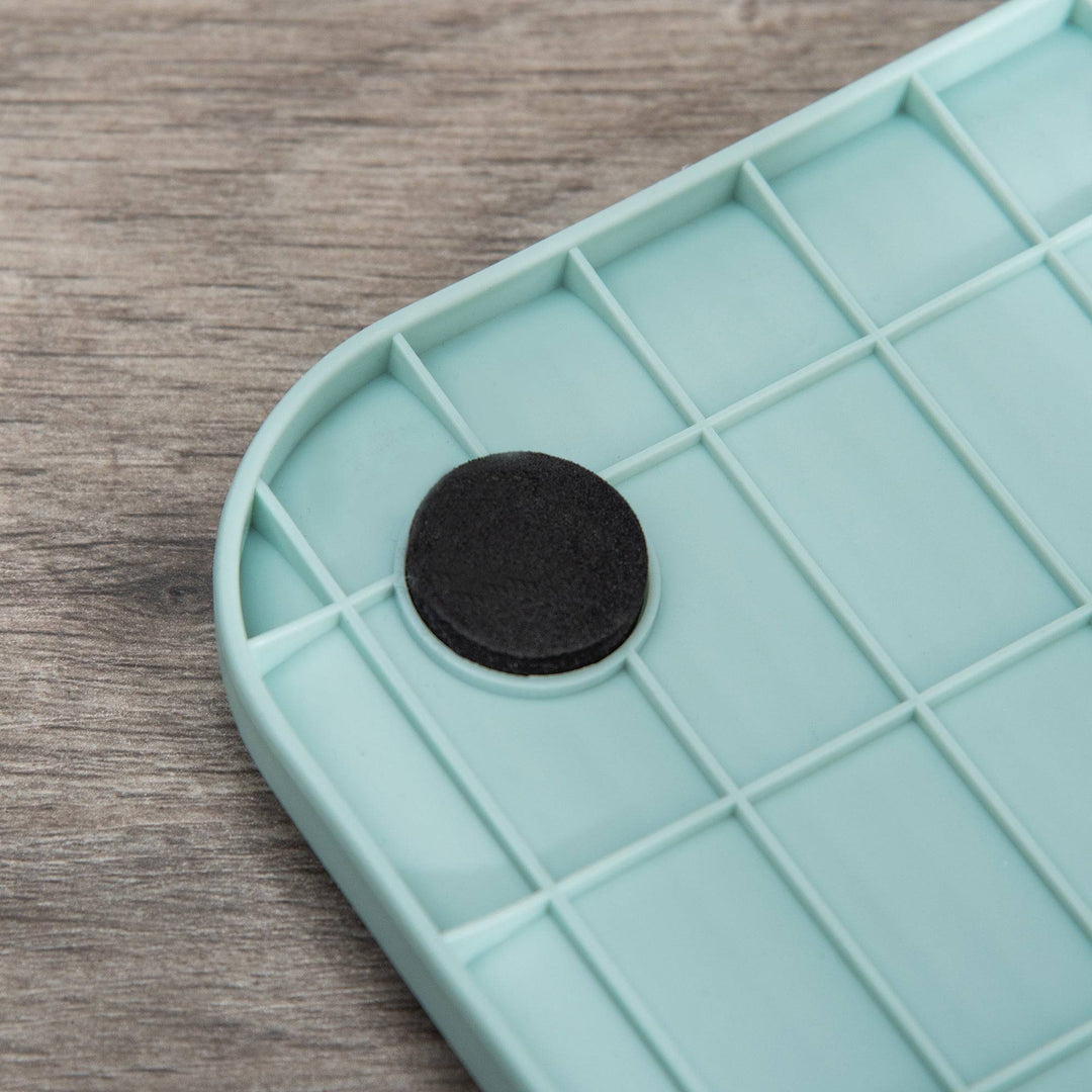 Close-up of the blue plastic base with anti-slip pad for enclosed cat litter box with lid, tray, and scoop.