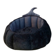 Soft plush black pumpkin-shaped pet bed with a cozy nest design and a pointed witch hat for cats and small dogs