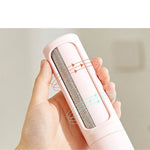 Load image into Gallery viewer, Close-up of pink 2-in-1 Pet Hair Remover Brush showing self-cleaning mechanism. Arrows indicate dual-direction brushing for effective lint removal.
