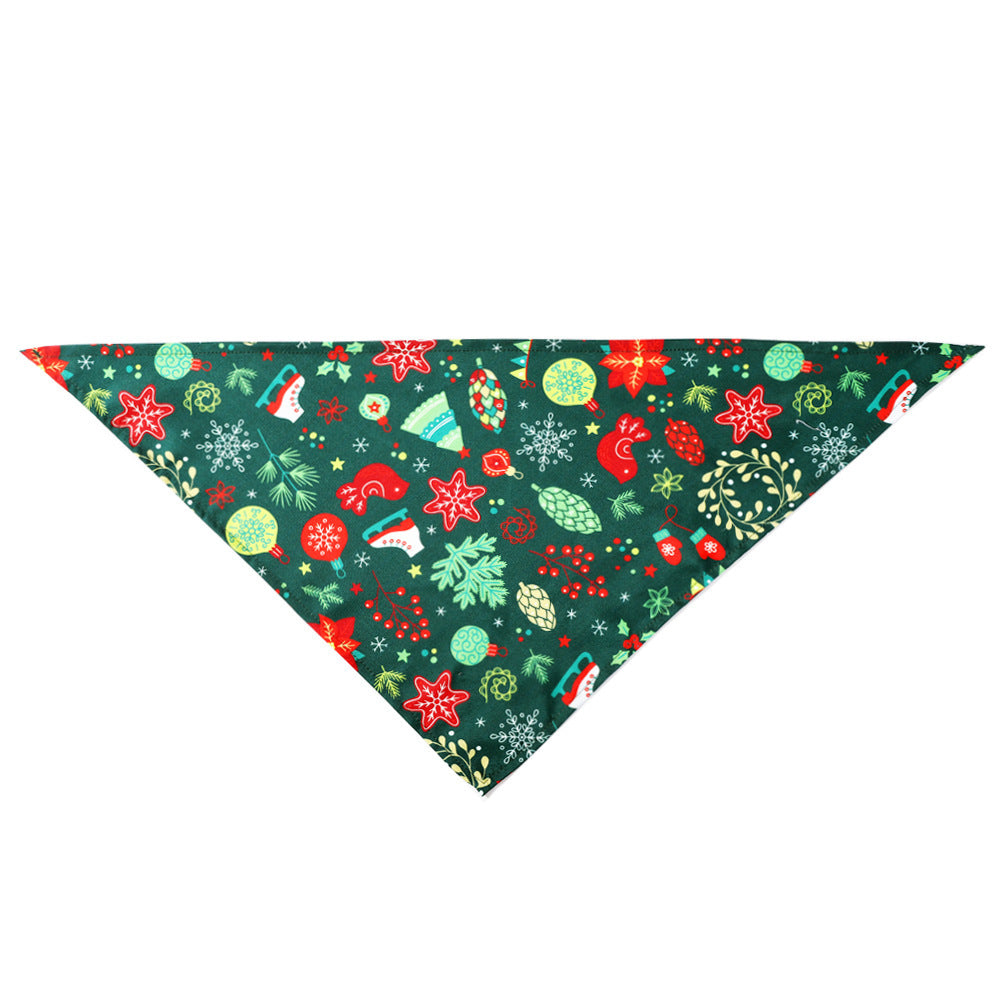 Christmas-themed dog bandana with festive patterns including snowflakes, stars, mittens, and ornaments on a green background.