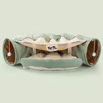Load image into Gallery viewer, Green collapsible cat tunnel with soft cushioned interior and interactive hanging pom-pom toys for durable play and comfort
