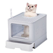 Grey enclosed cat litter box with slide-out tray and top-exit design featuring a cat inside the box