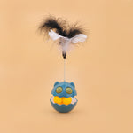 Load image into Gallery viewer, Blue rotating feather cat toy with interactive ball and catnip inside against beige background
