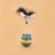 Blue rotating feather cat toy with interactive ball and catnip inside against beige background